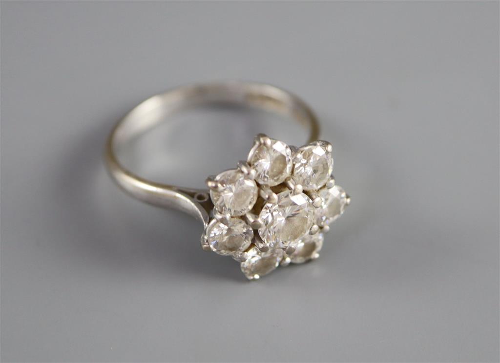 A modern 18ct white gold and eight stone diamond cluster flower head ring,